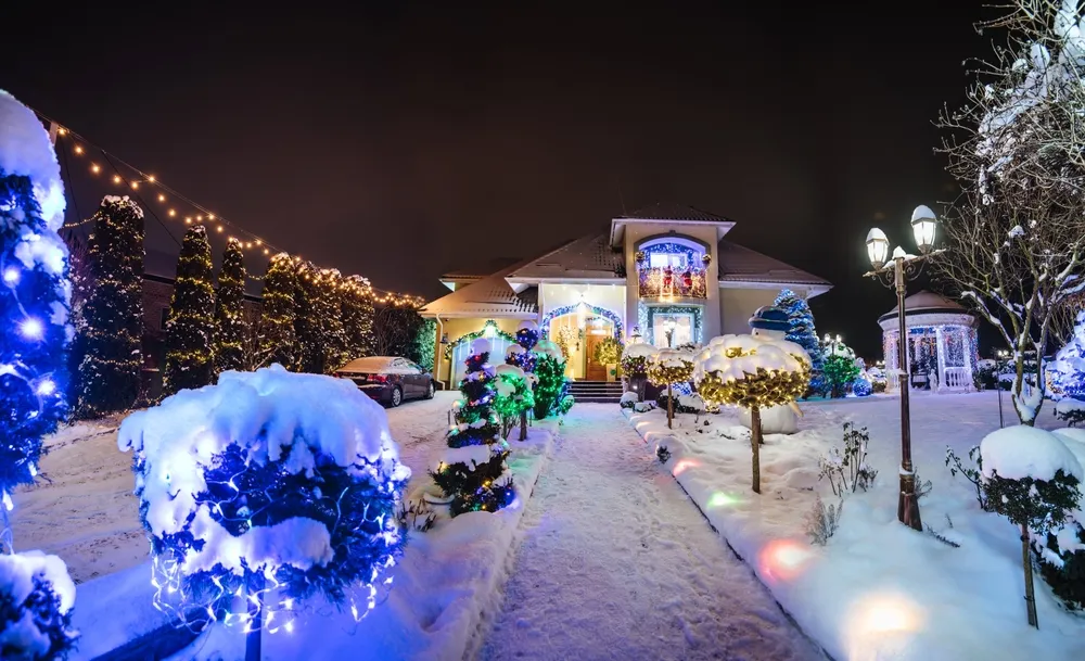 A snow-covered Ohio street with houses lit for the holidays